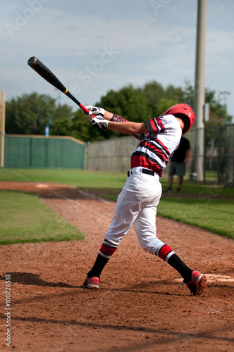 Youth baseball boy swinging bat