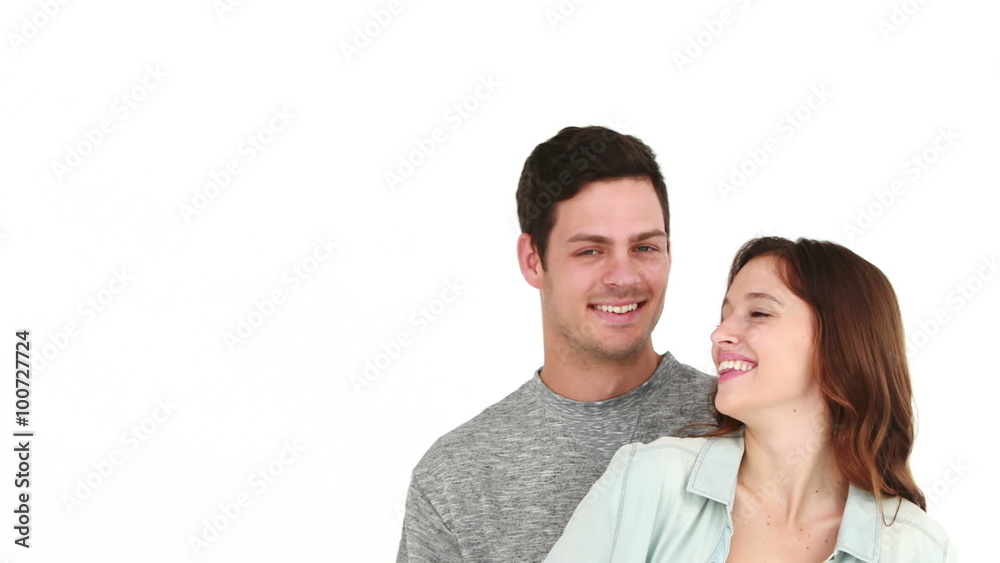 Smiling couple pointing away and embracing Smiling couple pointing away and embracing