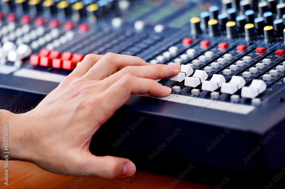 Hand adjusting audio mixer Hand adjusting audio mixer