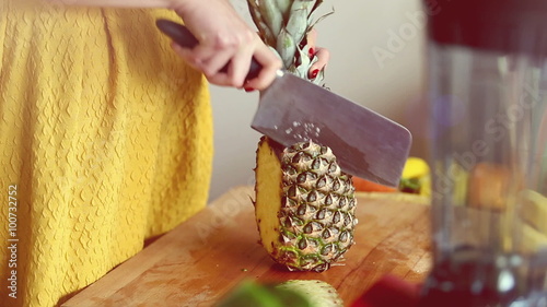View of woman hands cutting pineapple