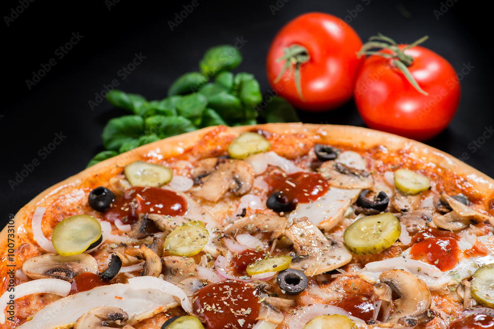 closeup Tasty pizza with tomatoes, mushroom, sausage, basil and closeup Tasty pizza with tomatoes, mushroom, sausage, basil and