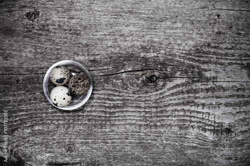 Composition with quail eggs. Wooden texture for background. Tone photo