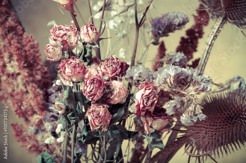Fototapeta Naklejka Na Ścianę i Meble -  Bouquet of dry flowers on burlap background. Selective focus. To