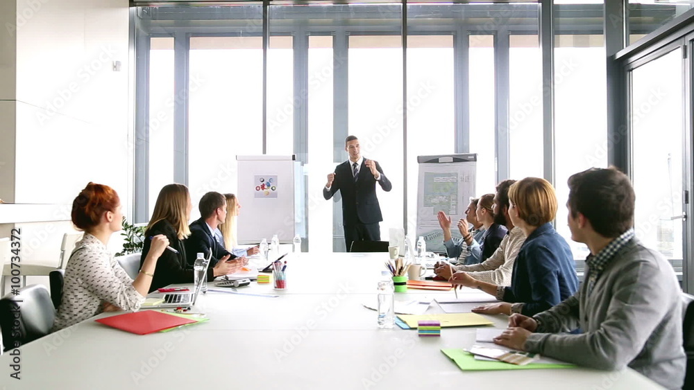 Business people applauding director during a meeting Business people applauding director during a meeting
