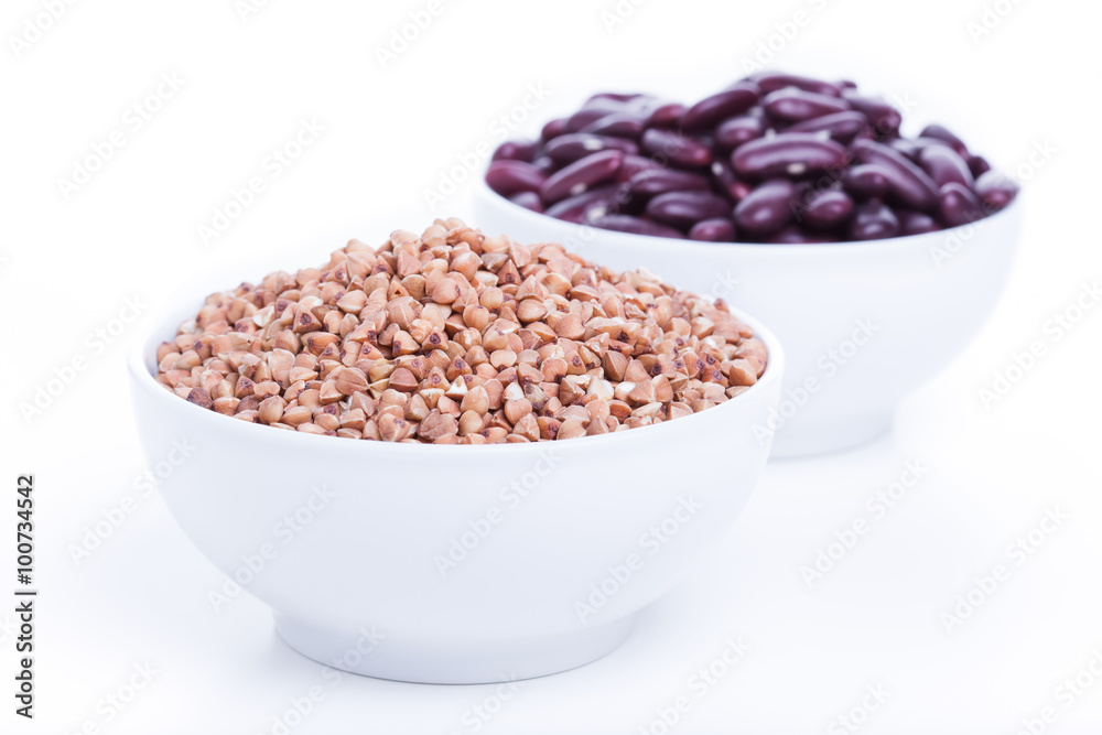 Dry buckwheat and black beans in white bowl Dry buckwheat and black beans in white bowl