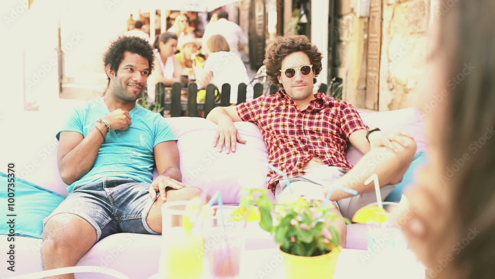 Two male friends sitting on terrace cafe in summer Two male friends sitting on terrace cafe in summer