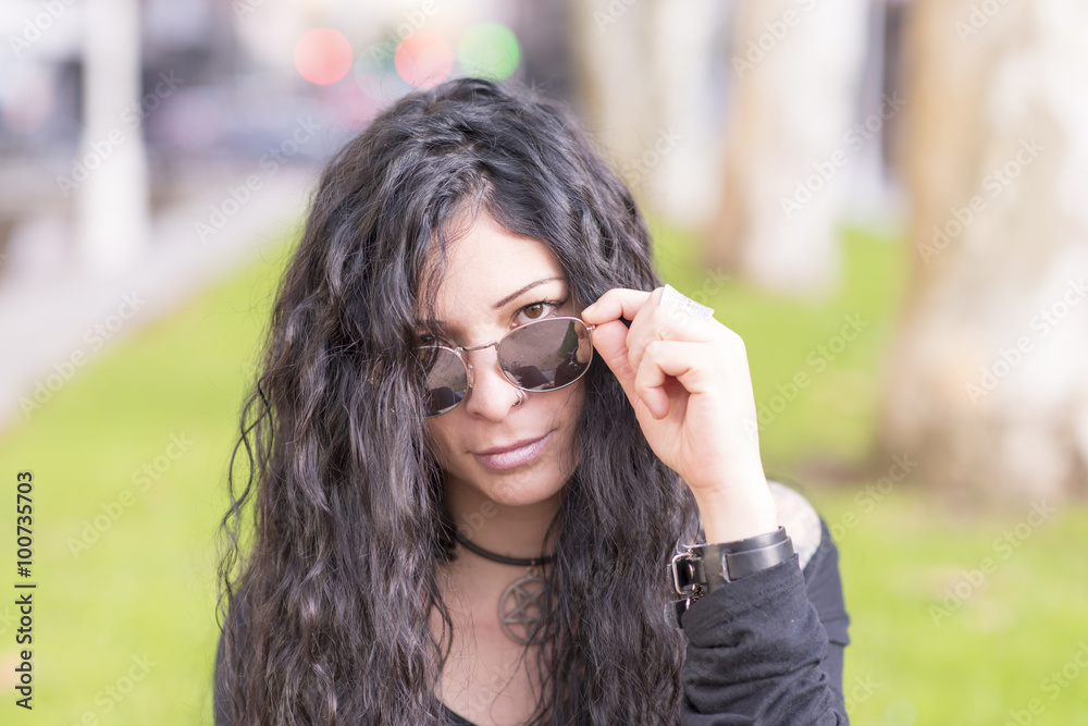 Urban portrait of woman with tattoo and sunglasses heavy metal style. Urban portrait of woman with tattoo and sunglasses heavy metal style.