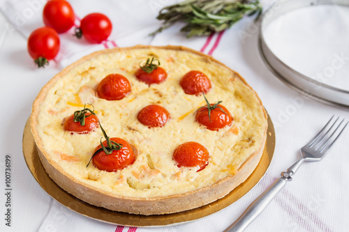 Traditional french quiche pie with salmon and cherry tomato