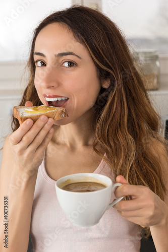Woman having breakfast with coffee