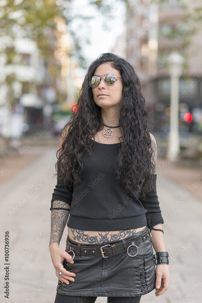 Urban portrait woman with tattoo sunglasses heavy metal style. Stock Photo  | Adobe Stock