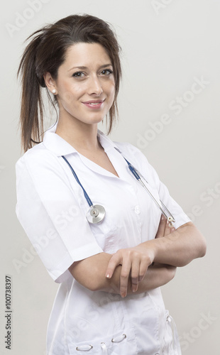 young female doctor with sthetoscop, looking at camera and smili photo