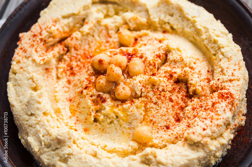 Homemade hummus of chickpeas, tahini paste and with paprika in a