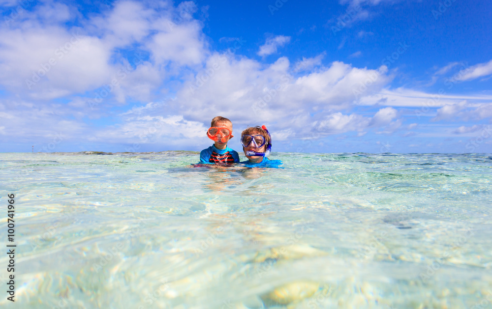 mother and son snorkeling on beach