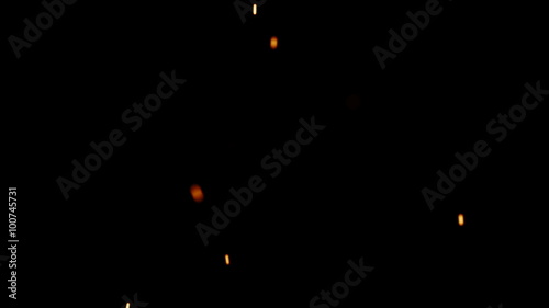 Rising Embers, Low Flames (24fps). Fire on low heat, hot burning embers rise up. The shallow focus makes the particles bokeh. photo