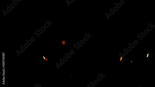 Rising Embers, Low Flames (25fps). Fire on low heat, hot burning embers rise up. The shallow focus makes the particles bokeh. photo