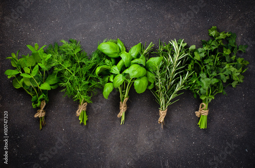 Fresh herbs on dark background photo