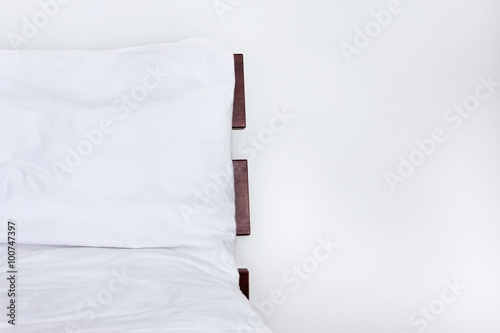 White bed with bed sheets on wood bed isolated on white background