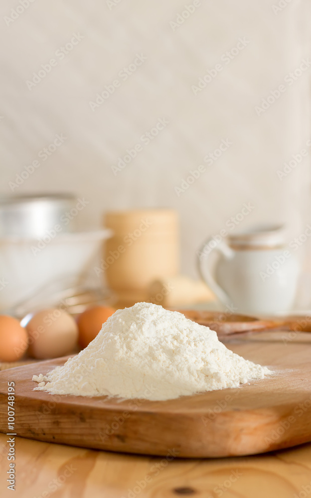 White wheat flour and raw eggs for making dough and kitchen utensils against a white wall. Concept of rustic kitchen, selective focus. Copy space. Free space for text White wheat flour and raw eggs for making dough and kitchen utensils against a white wall. Concept of rustic kitchen, selective focus. Copy space. Free space for text