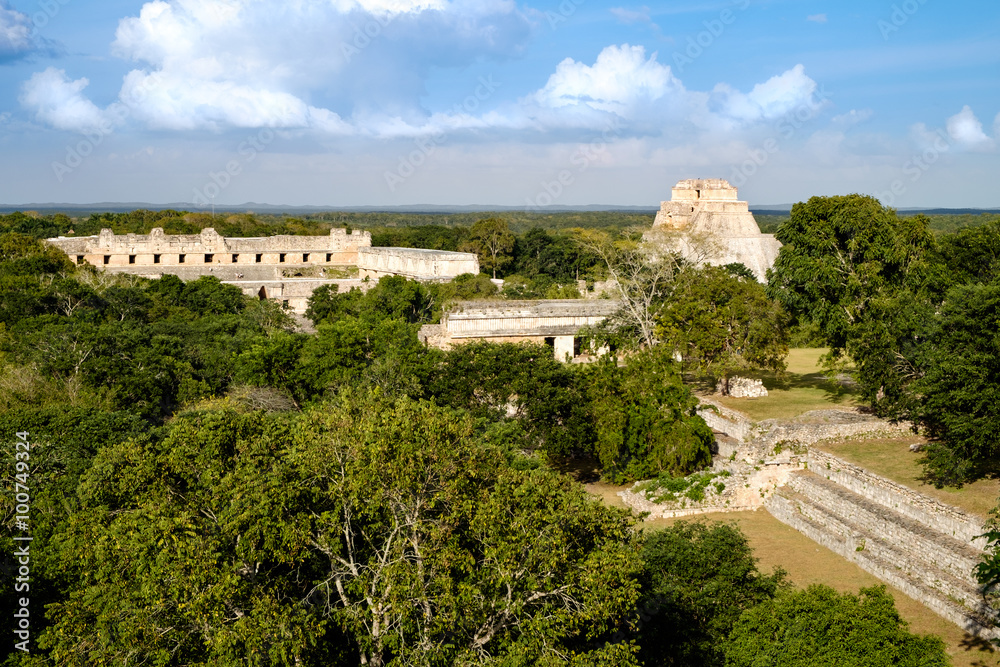Landscape view of Uxmal archeological site with pyramids and rui