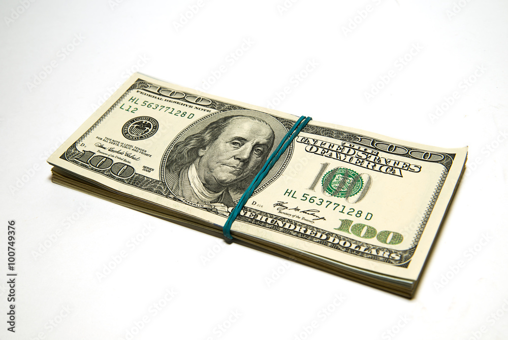 Bundle of US dollars banknotes on over white Bundle of US dollars banknotes on over white
