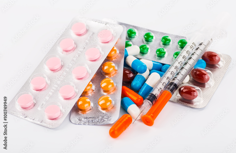 Various cold prescription bottles and a syringe isolated on a wh