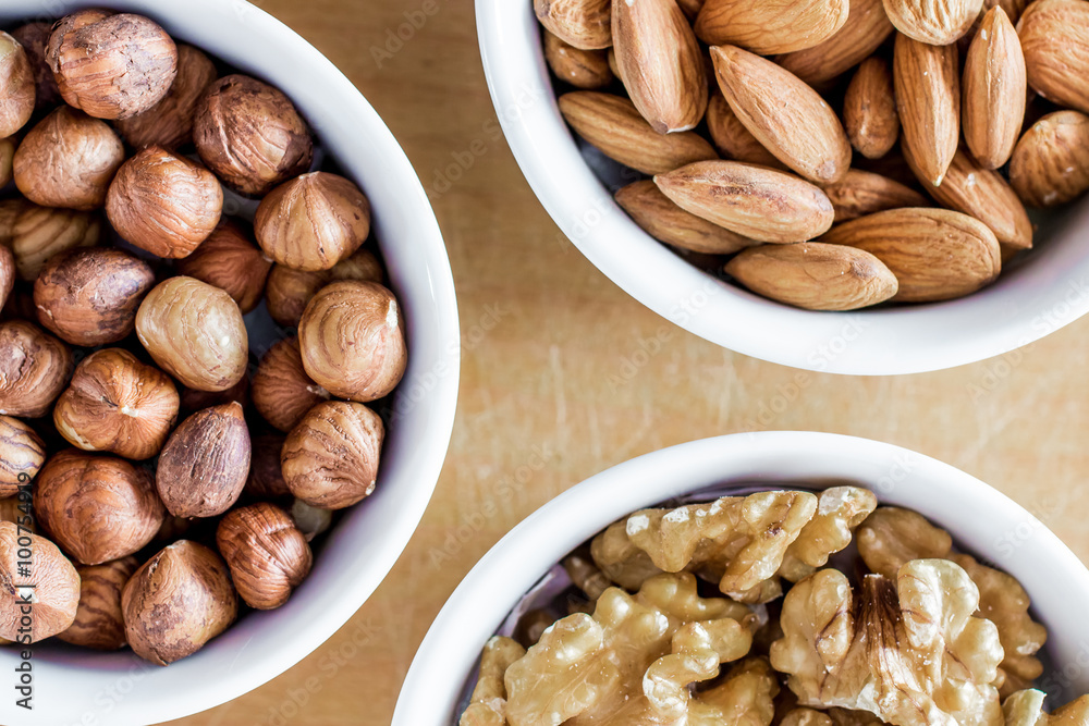 Three bowls of assorted nuts Three bowls of assorted nuts