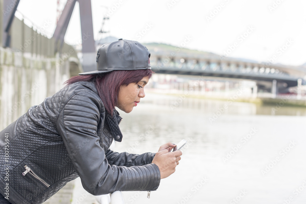 Fasion smiling woman using smart phone. Fasion smiling woman using smart phone.