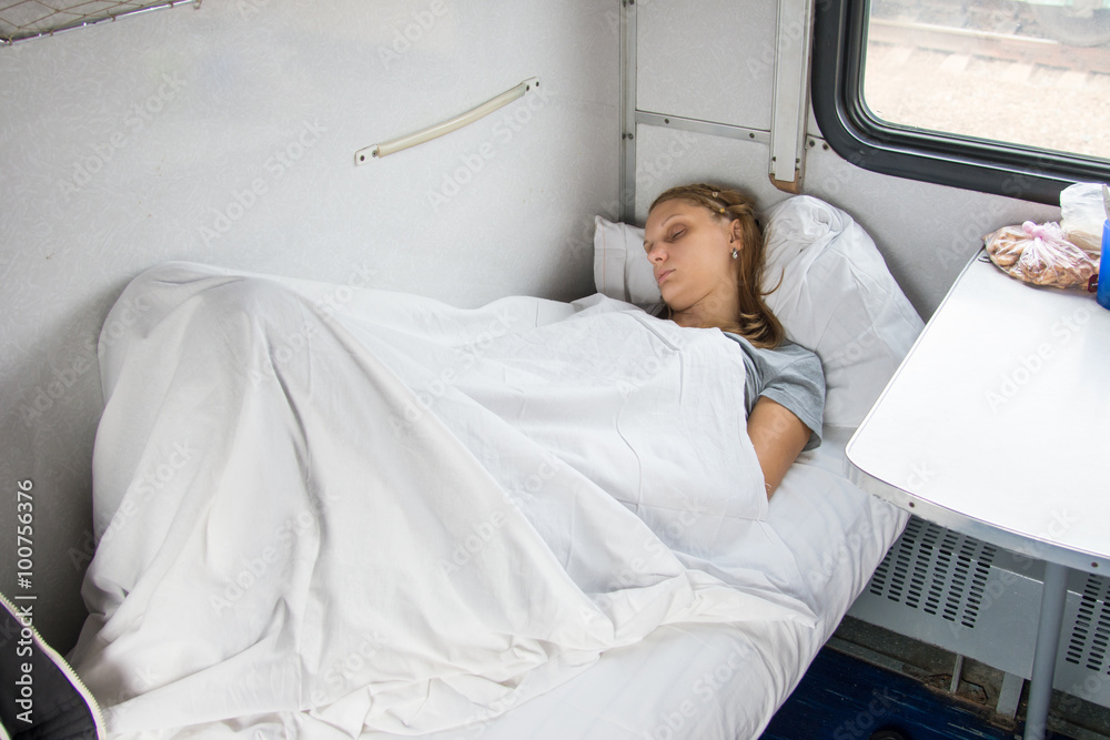 Tired young girl sleeping on a train Tired young girl sleeping on a train