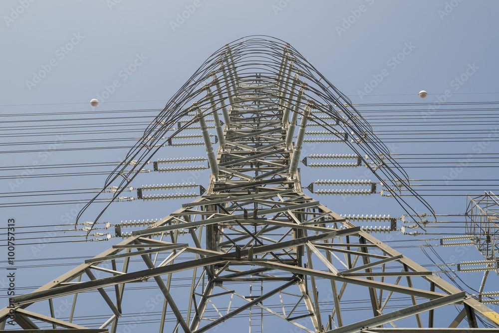 High voltage post electric power transmission tower and the blue sky background