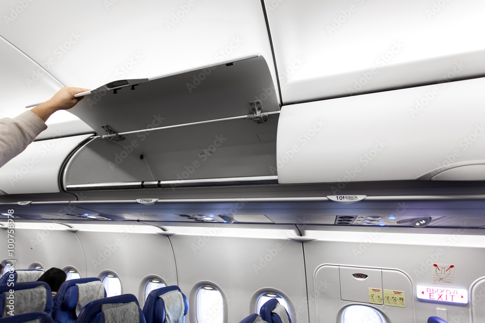Fototapeta premium Airplane interior with luggage compartments