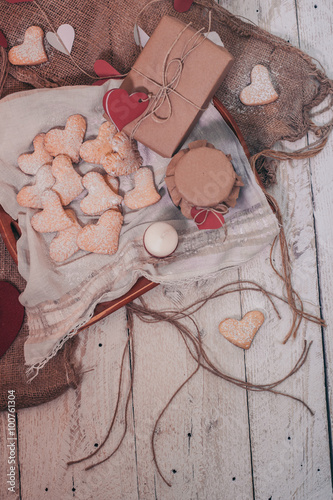 Heart shape cookies on wooden background with gift box