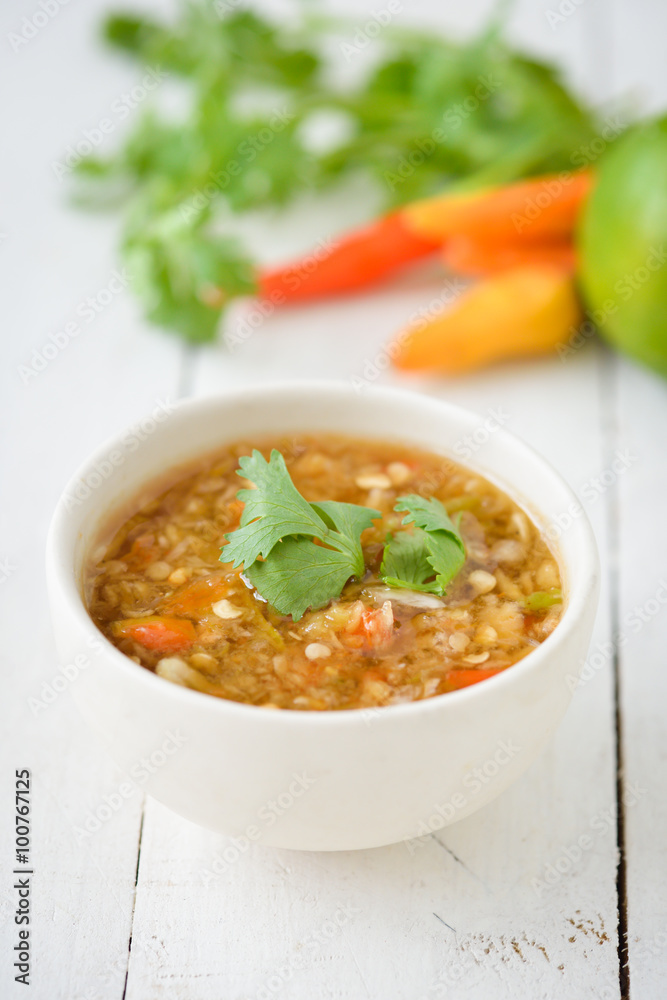 Spicy seafood dipping sauce for seafood on wood background Spicy seafood dipping sauce for seafood on wood background