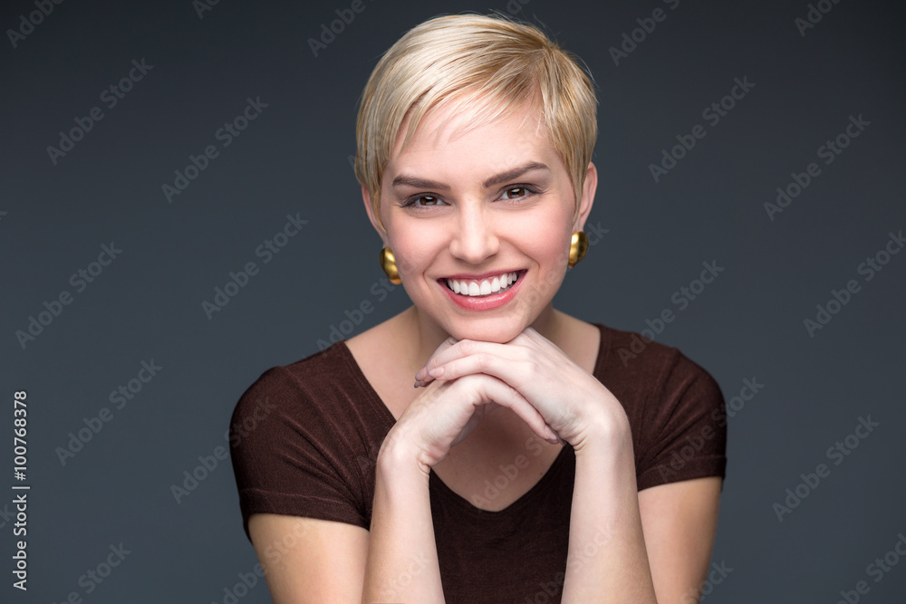 Fototapeta premium Blonde short pixie haircut portrait fun charming smile perfect teeth confident business woman professional