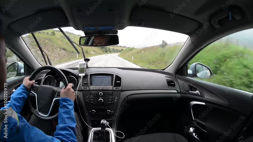 man driving a car with gps navigation system and phone smart phone app man driving a car with gps navigation system and phone smart phone app