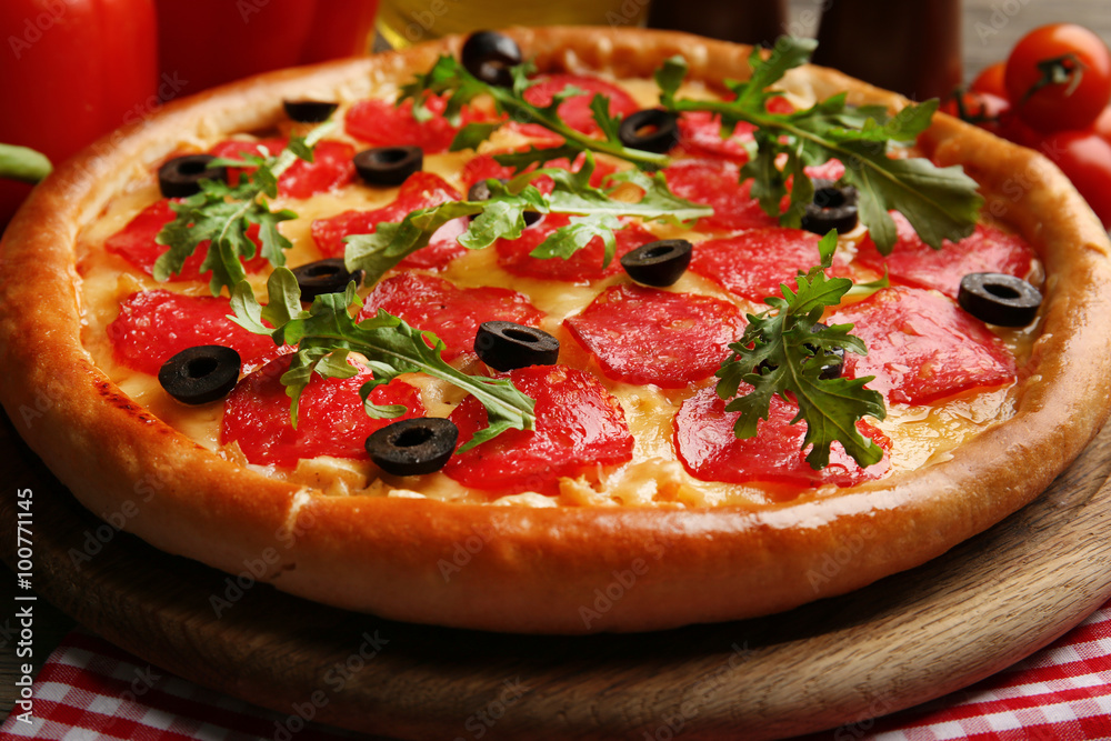 Tasty pizza with salami on decorated wooden table, close up