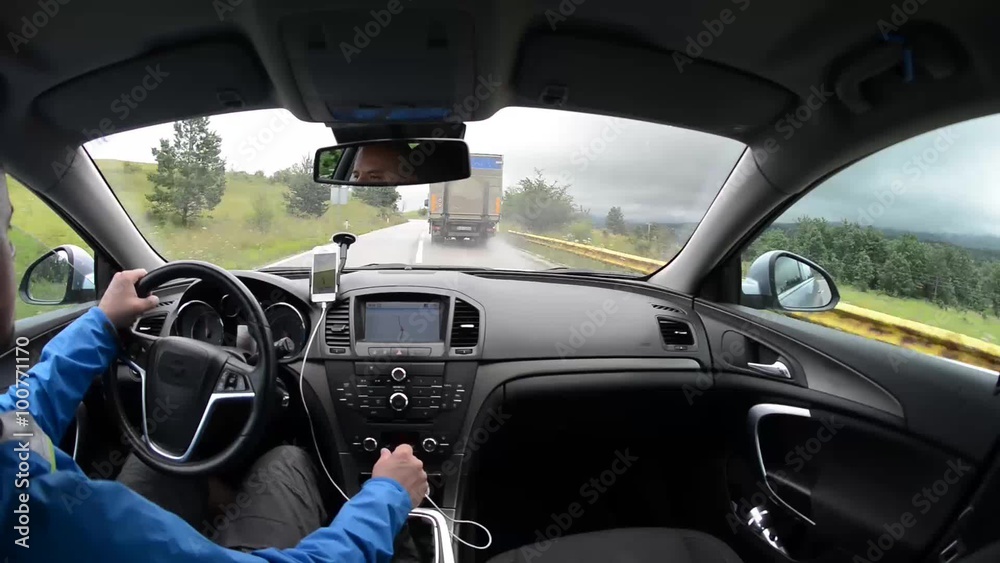 man driving a car with gps navigation system and phone smart phone app man driving a car with gps navigation system and phone smart phone app