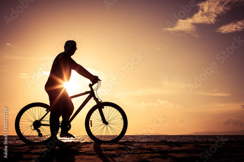 Wallpaper Mural happy man standing on the beach at the sunset Torontodigital.ca
