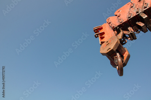 Red crane arm against the blue sky