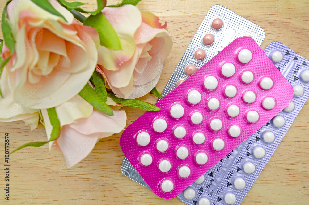 Oral contraceptive pill strips on pine wood table. Oral contraceptive pill strips on pine wood table.
