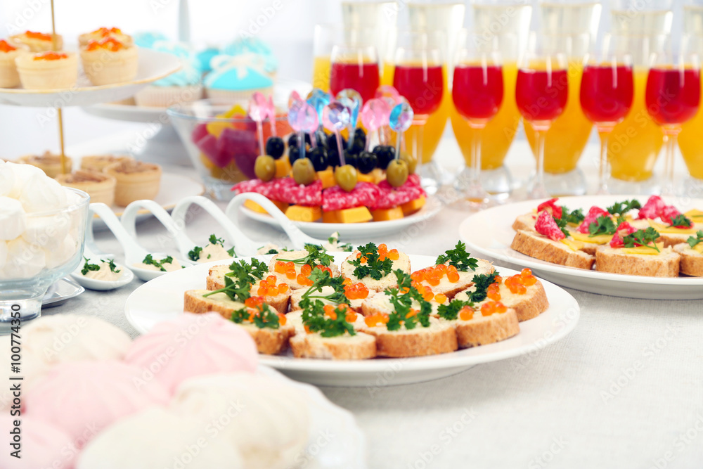 Set of cold snacks, canape, beverages, closeup Set of cold snacks, canape, beverages, closeup