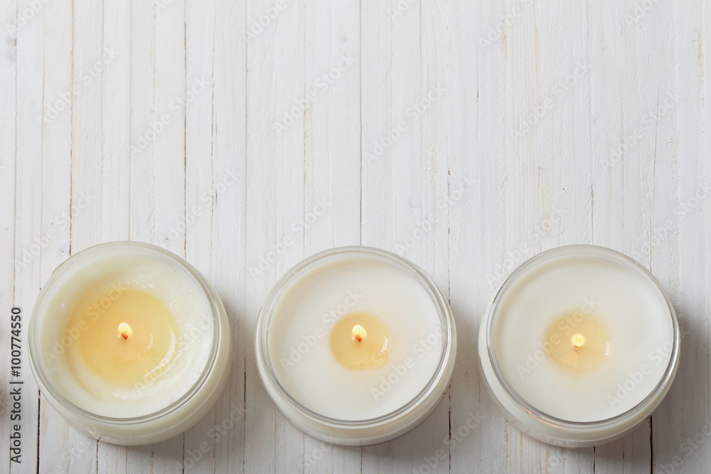 scented candles on white wooden background - obrazy, fototapety, plakaty 