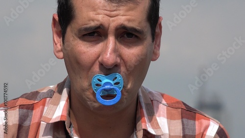 Adult Man Using Baby Pacifier photo