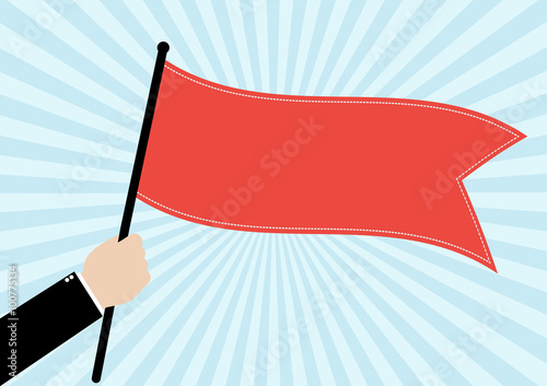 Businessman hold a red flag on bright blue sunrays background. 