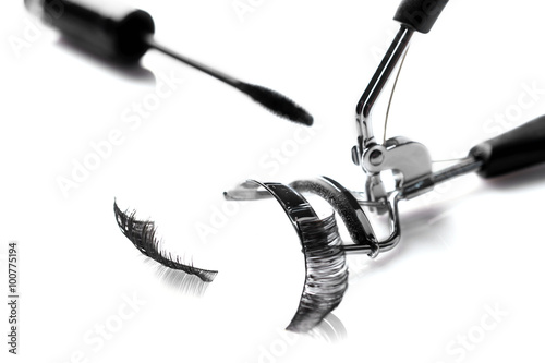 Curler, mascara brush and false eyelashes, isolated on white