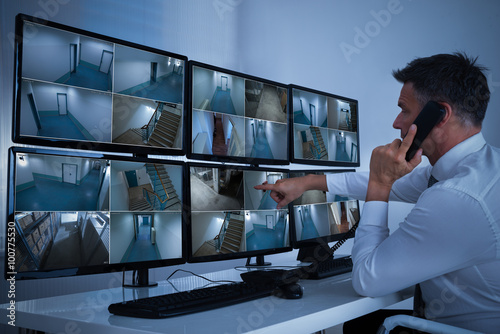 Security System Operator Looking At CCTV Footage