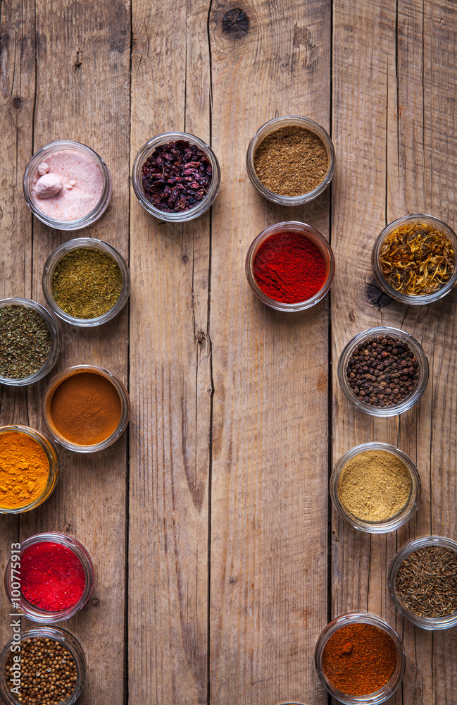 Spices in jars on wooden background. Food Spices in jars on wooden background. Food