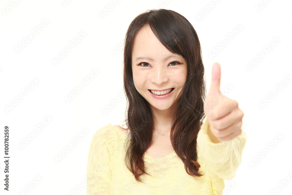 young Japanese woman with thumbs up gesture young Japanese woman with thumbs up gesture