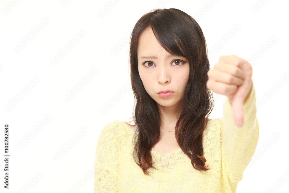 young Japanese businesswoman with thumbs down gesture young Japanese businesswoman with thumbs down gesture