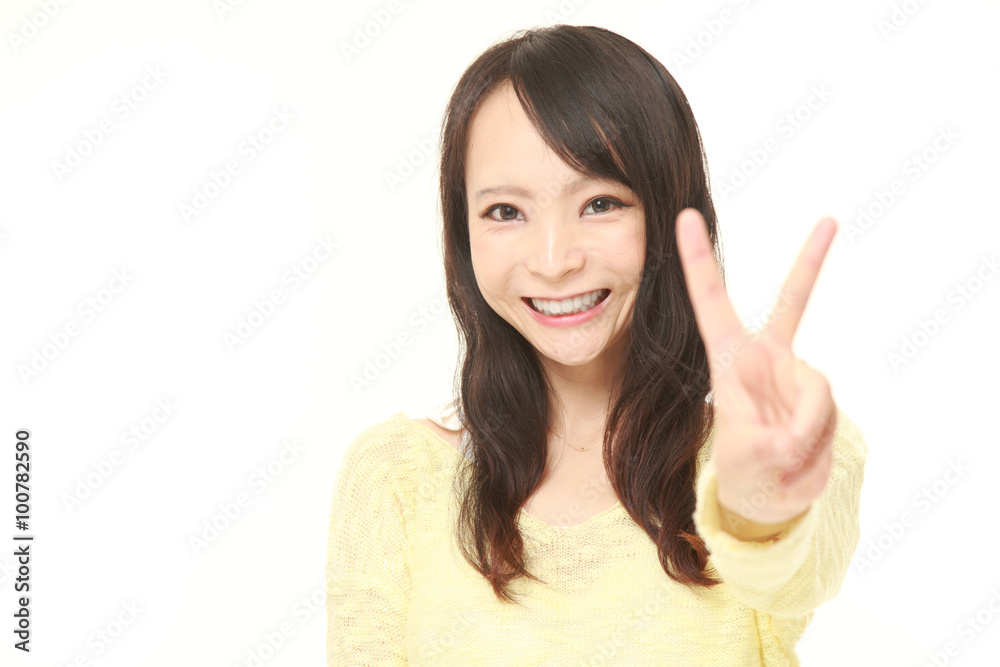 young Japanese woman showing a victory sign young Japanese woman showing a victory sign