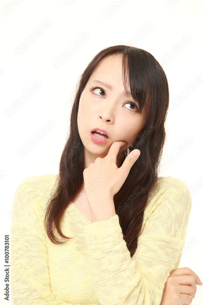 young Japanese woman worries about something young Japanese woman worries about something